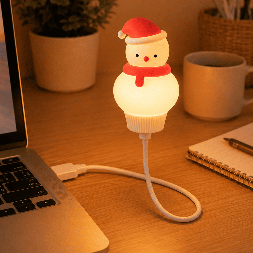veilleuse usb bonhomme de neige sur une table branchée à un ordinateur 